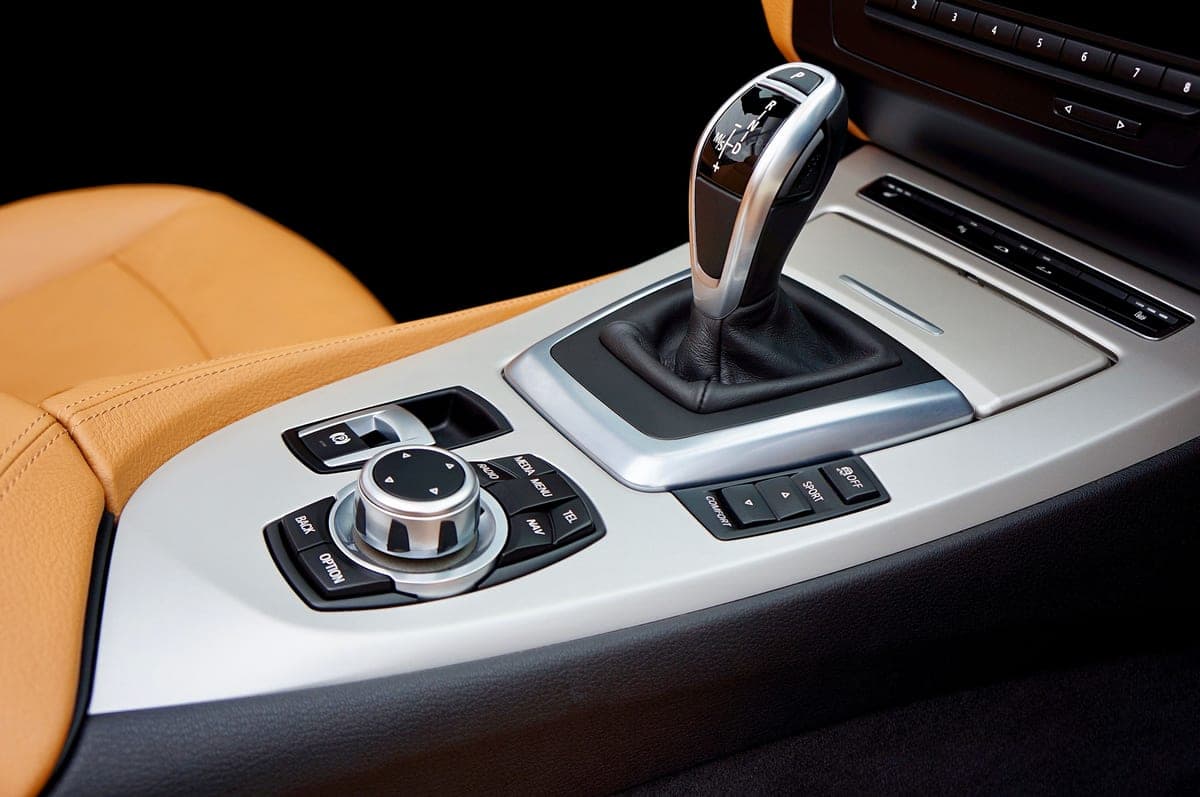 A clean car interior with detailed dashboard and seats in daylight