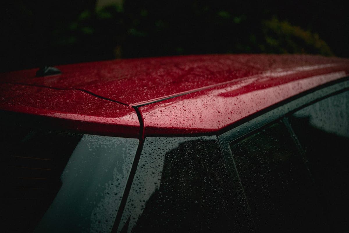 Water beading tightly on a freshly waxed glossy paint panel